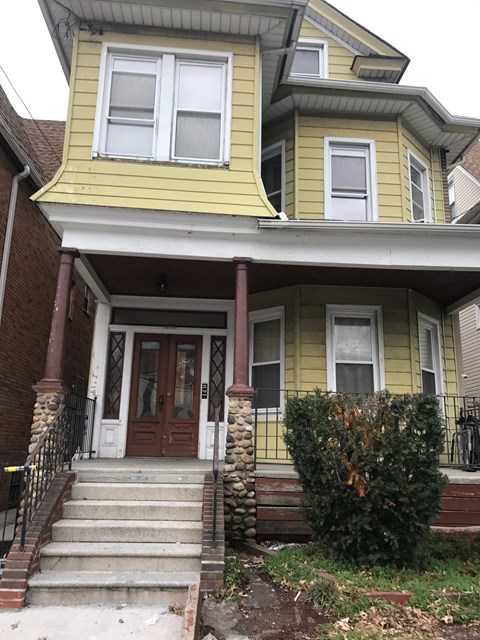 a yellow house with steps in front of it