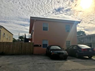 a house with two cars parked in front of it