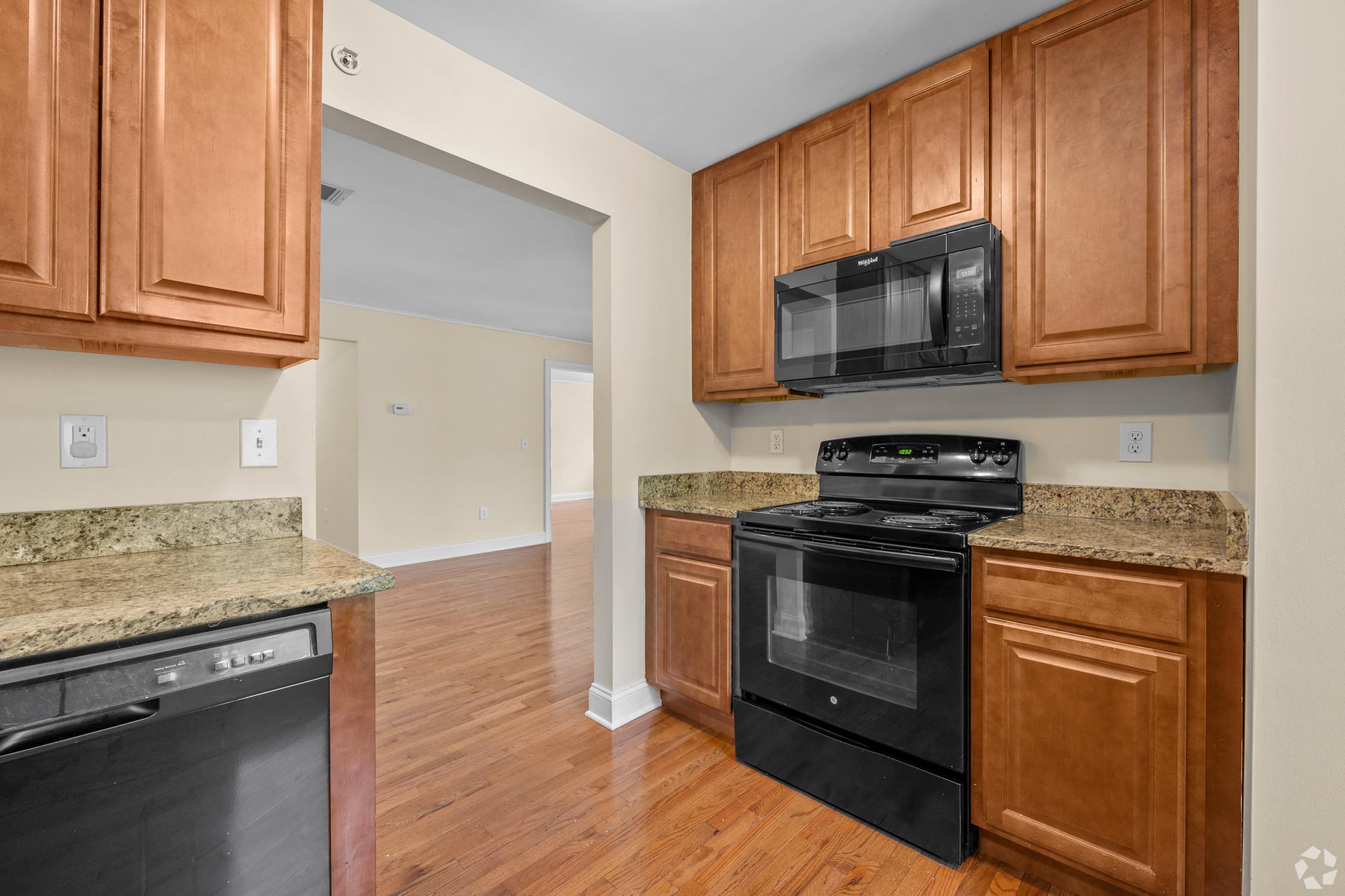 a kitchen with black appliances and granite counter tops