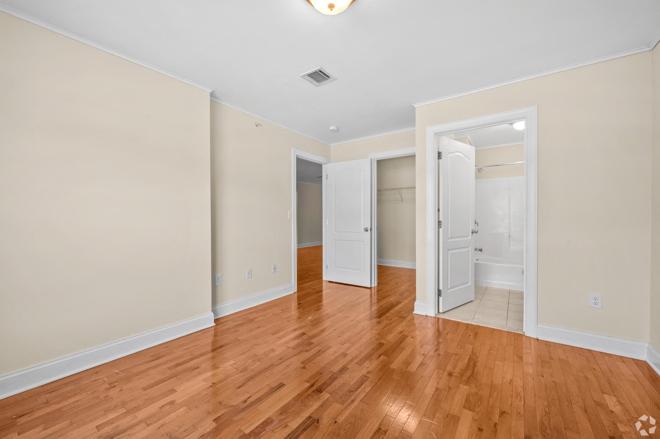 a renovated living room with wood floors and white walls