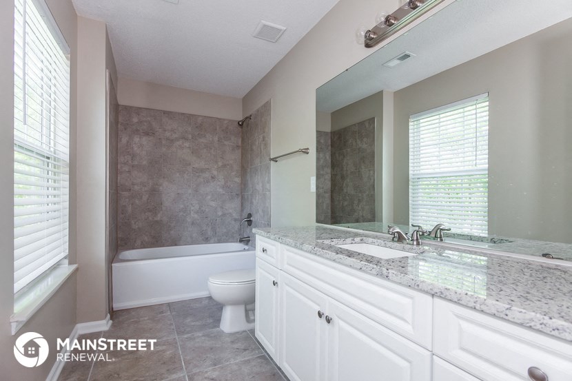 a bathroom with a sink and a toilet and a tub