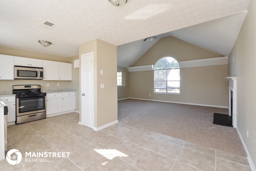 the kitchen and living room of an attic apartment