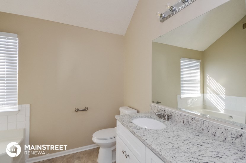 a bathroom with a sink and a toilet and a mirror