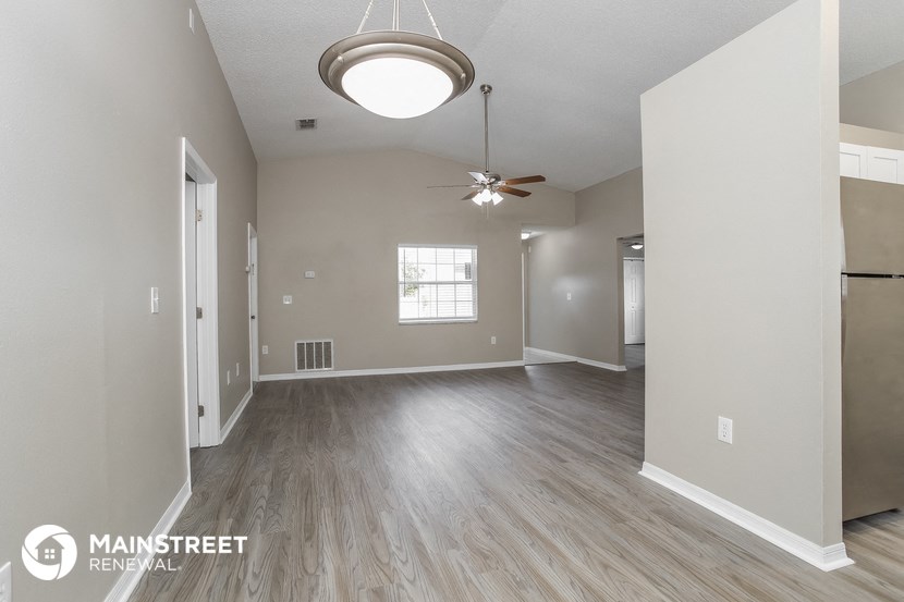 the living room and dining room of an open floor plan