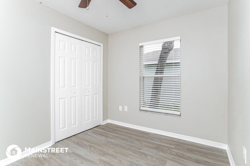 the living room of a new home with white walls and wood floors
