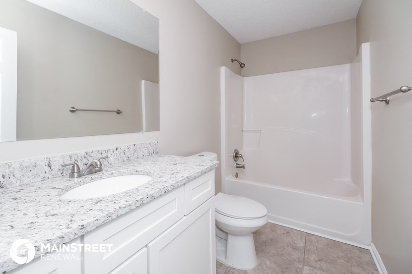 a bathroom with a sink and a toilet and a shower