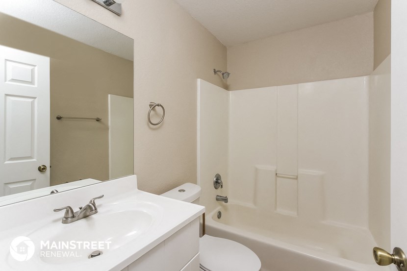 a bathroom with a sink and a shower and a toilet