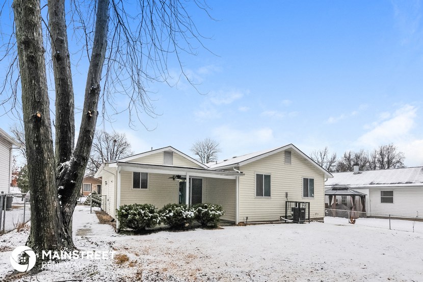 a white house with snow on the ground