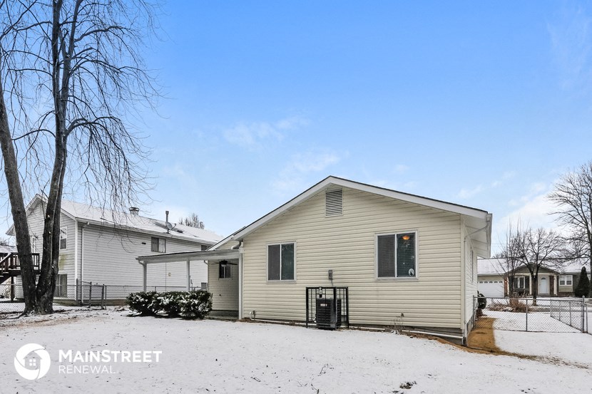 a white house with snow on the ground