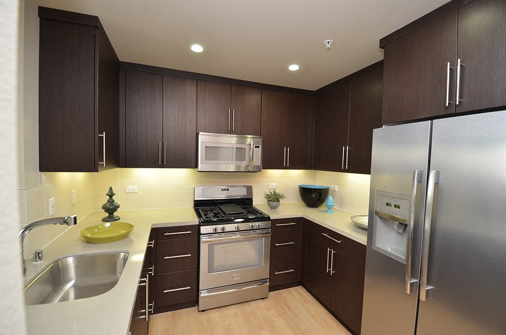 a kitchen with stainless steel appliances and wooden cabinets