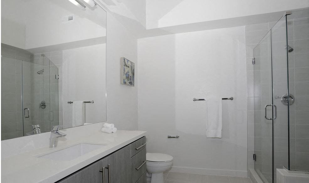 a bathroom with a sink toilet and a shower