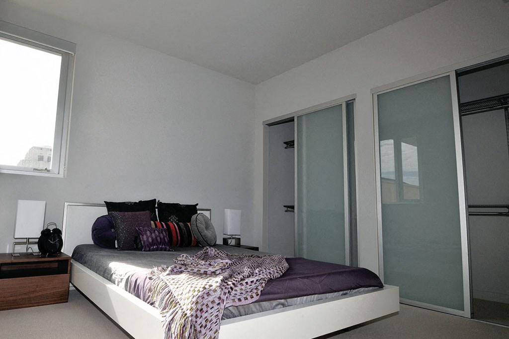 a bedroom with a bed and some pillows on it