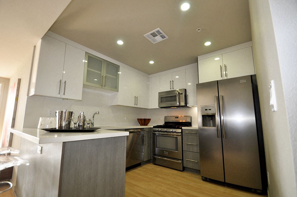 a kitchen with stainless steel appliances and white cabinets
