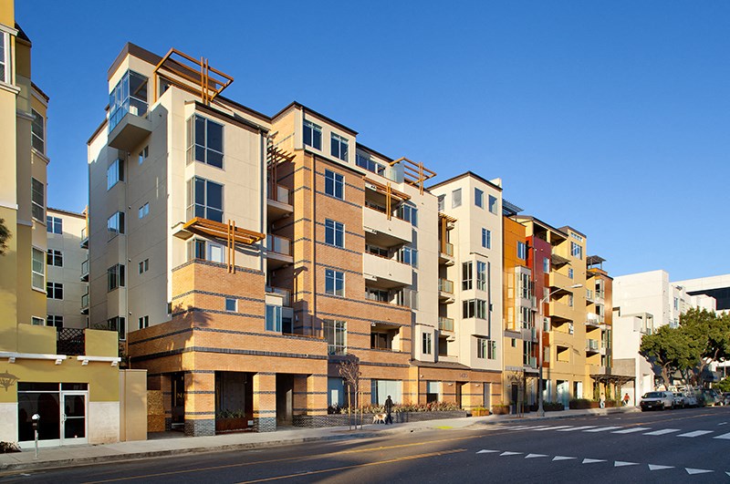 a row of apartment buildings on a city street