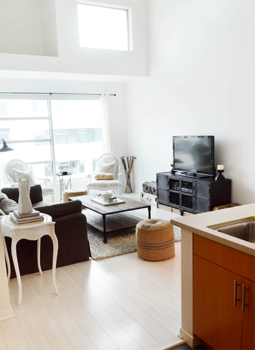 a living room with a couch and a table and a television