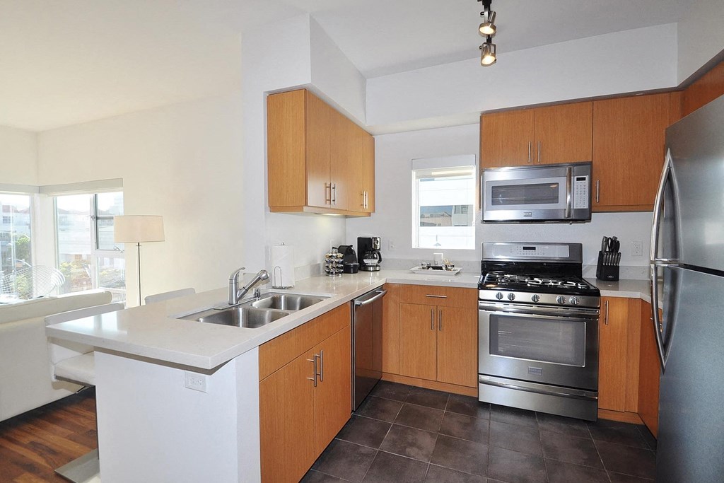 a kitchen with stainless steel appliances and wooden cabinets