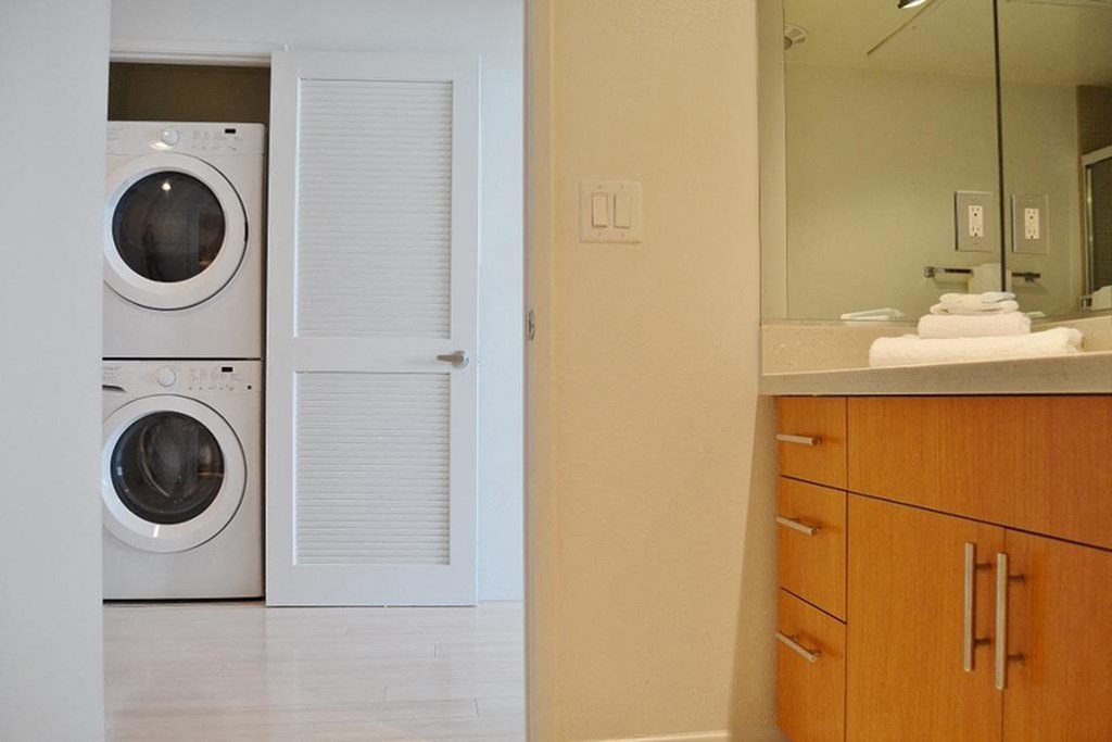 a bathroom with a washer and a dryer in it