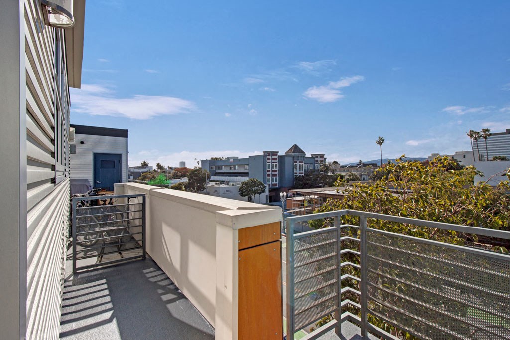 a small balcony with a view of the city