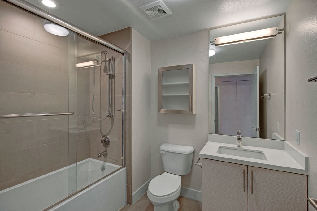 a bathroom with a shower toilet and sink