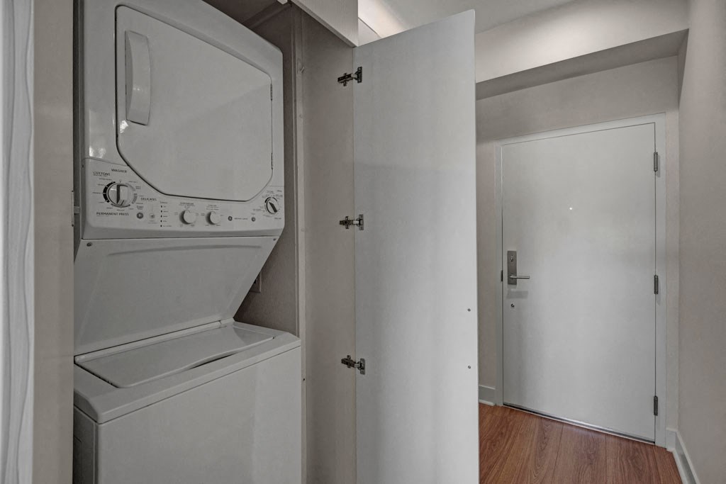 a white washer and dryer in a room with a door