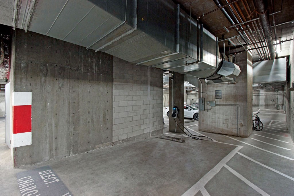 a parking garage with a white car in it