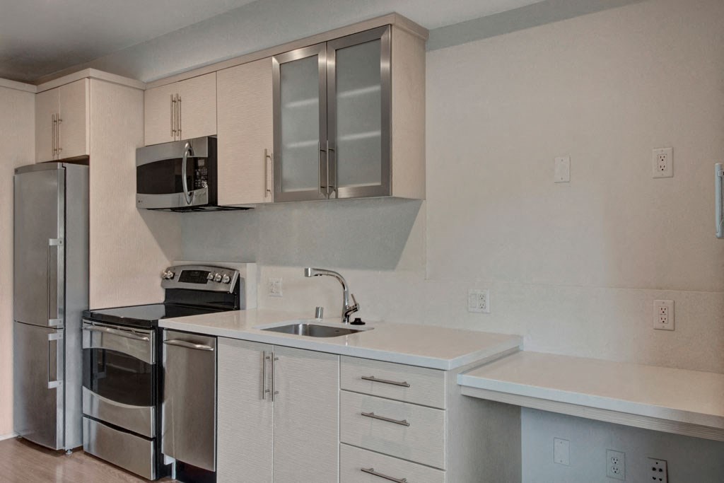 a kitchen with a sink and a refrigerator