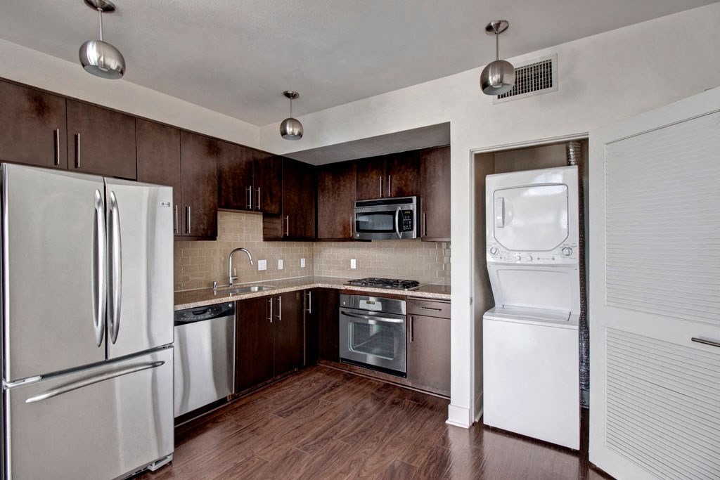 a kitchen with stainless steel appliances and a white refrigerator