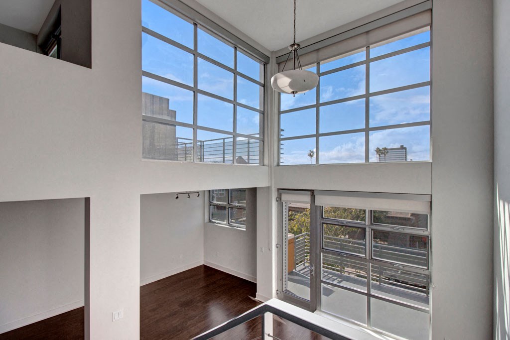 a living room with high ceilings and large windows