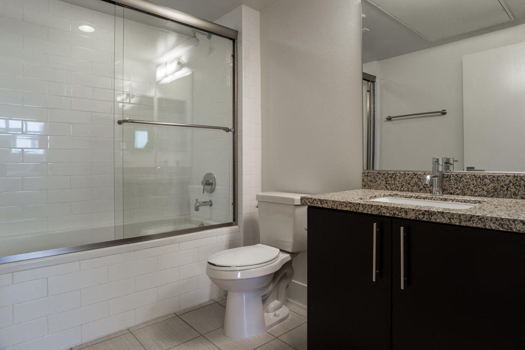 a bathroom with a toilet and a sink and a shower