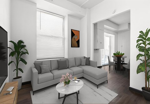 a living room with a gray couch and a white table