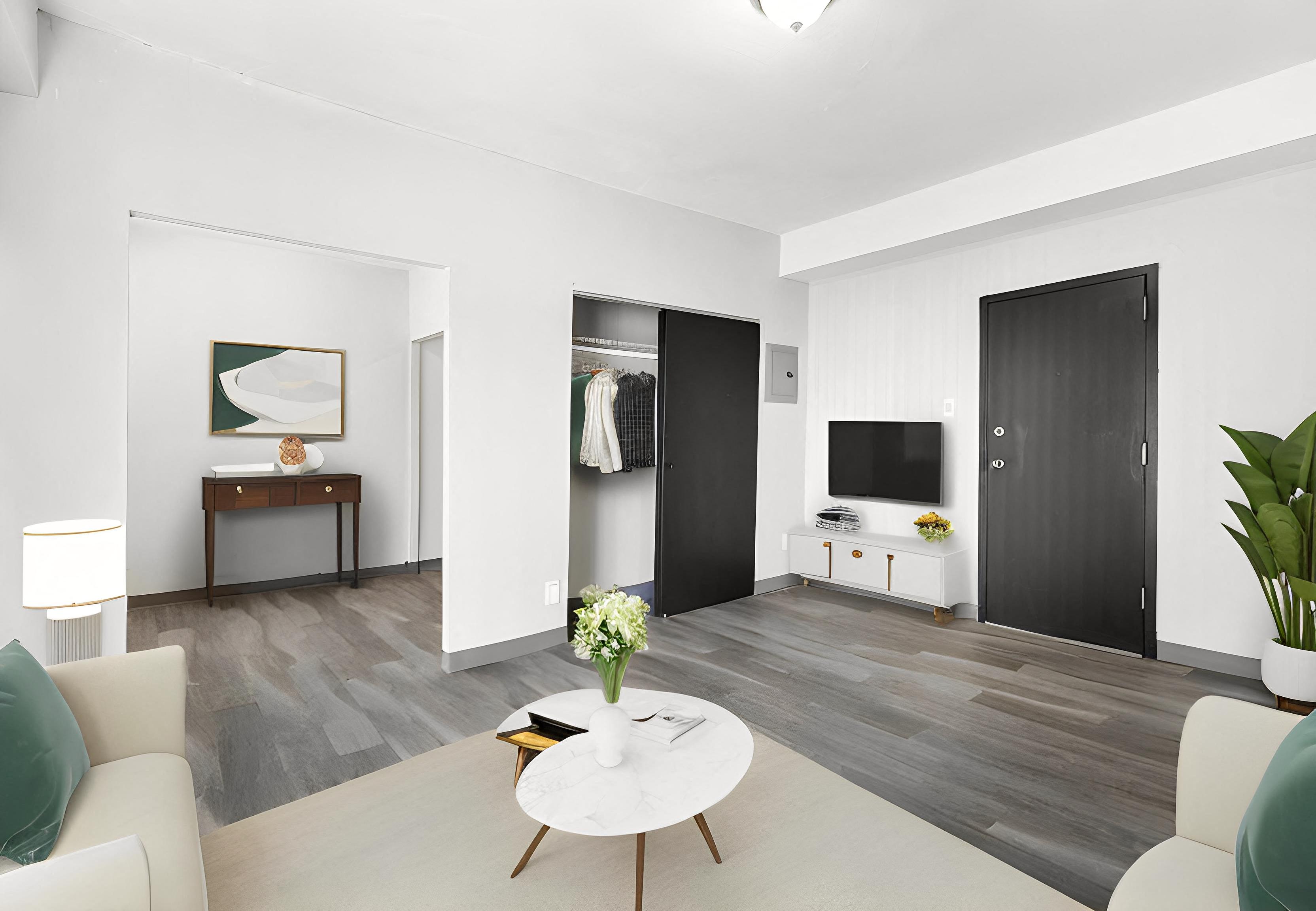 a living room with a couch and a coffee table and a television