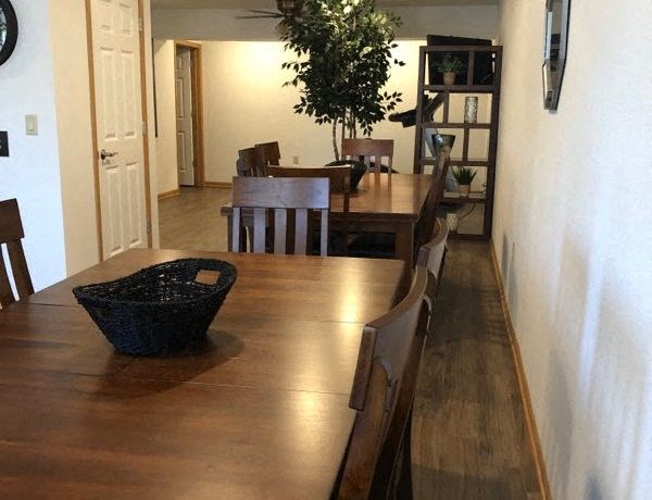 a dining room with a wooden table and chairs