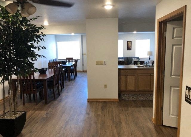 an empty living room and dining room with a table and chairs