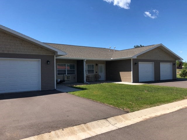 a house with two garage doors and a lawn