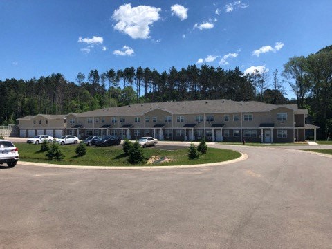 an empty parking lot in front of an apartment building