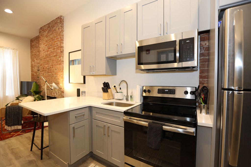 a kitchen with stainless steel appliances and white cabinets