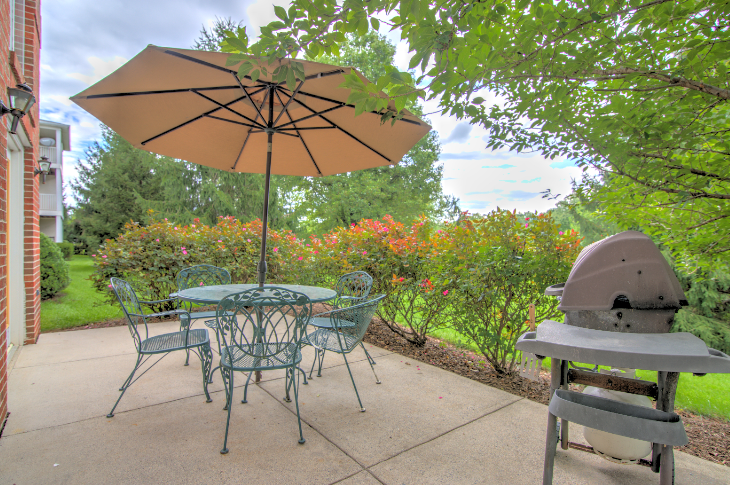 barbecue area at Creekside at Taskers Chance in Frederick, MD with dining table and chairs and barbecue grill