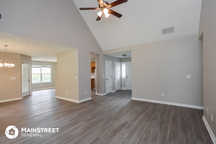 the living room and dining room of an open floor plan