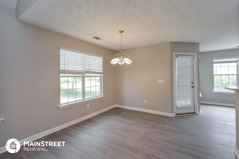 the living room and dining room of an empty renovated house