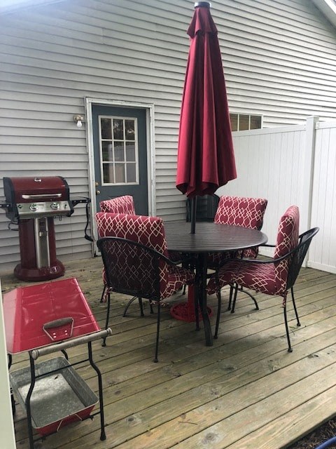 a patio with a table and chairs and an umbrella
