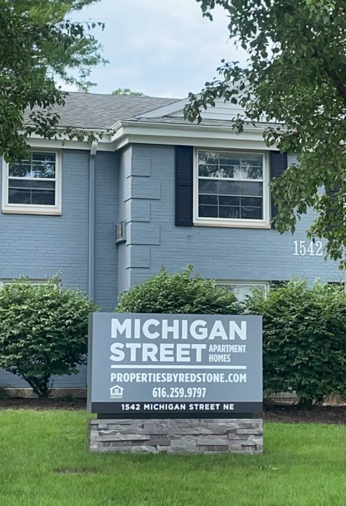a sign street in front of a house