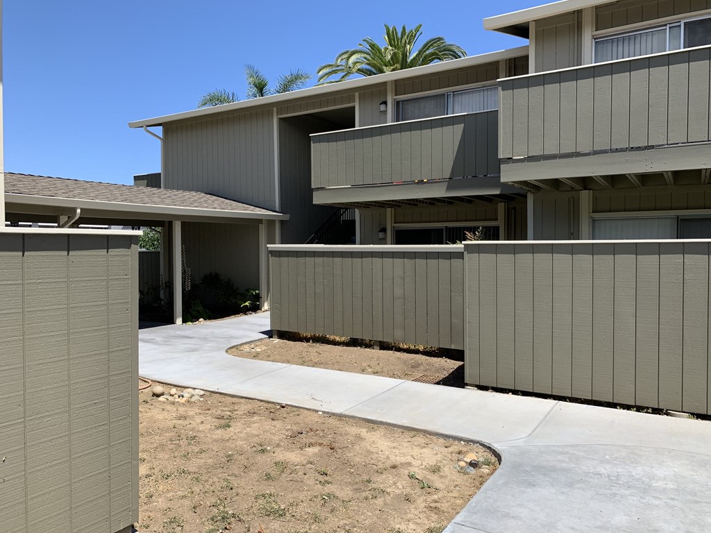 a view of a house with a fence in front of it