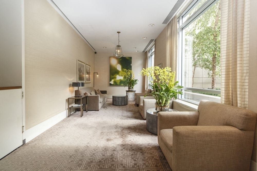 a living room with brown couches and a large window
