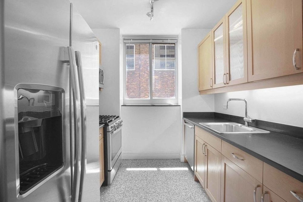 a kitchen with a sink and a refrigerator