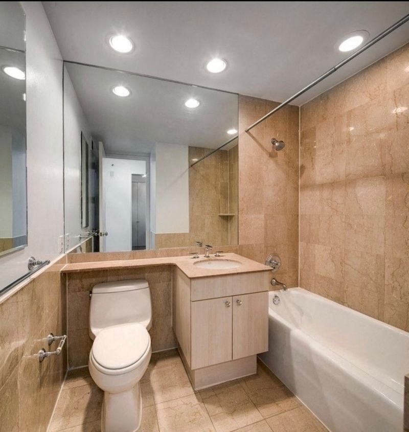 a bathroom with a toilet and a tub and a sink