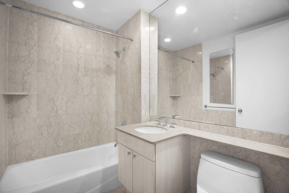 a bathroom with a sink toilet and a bath tub