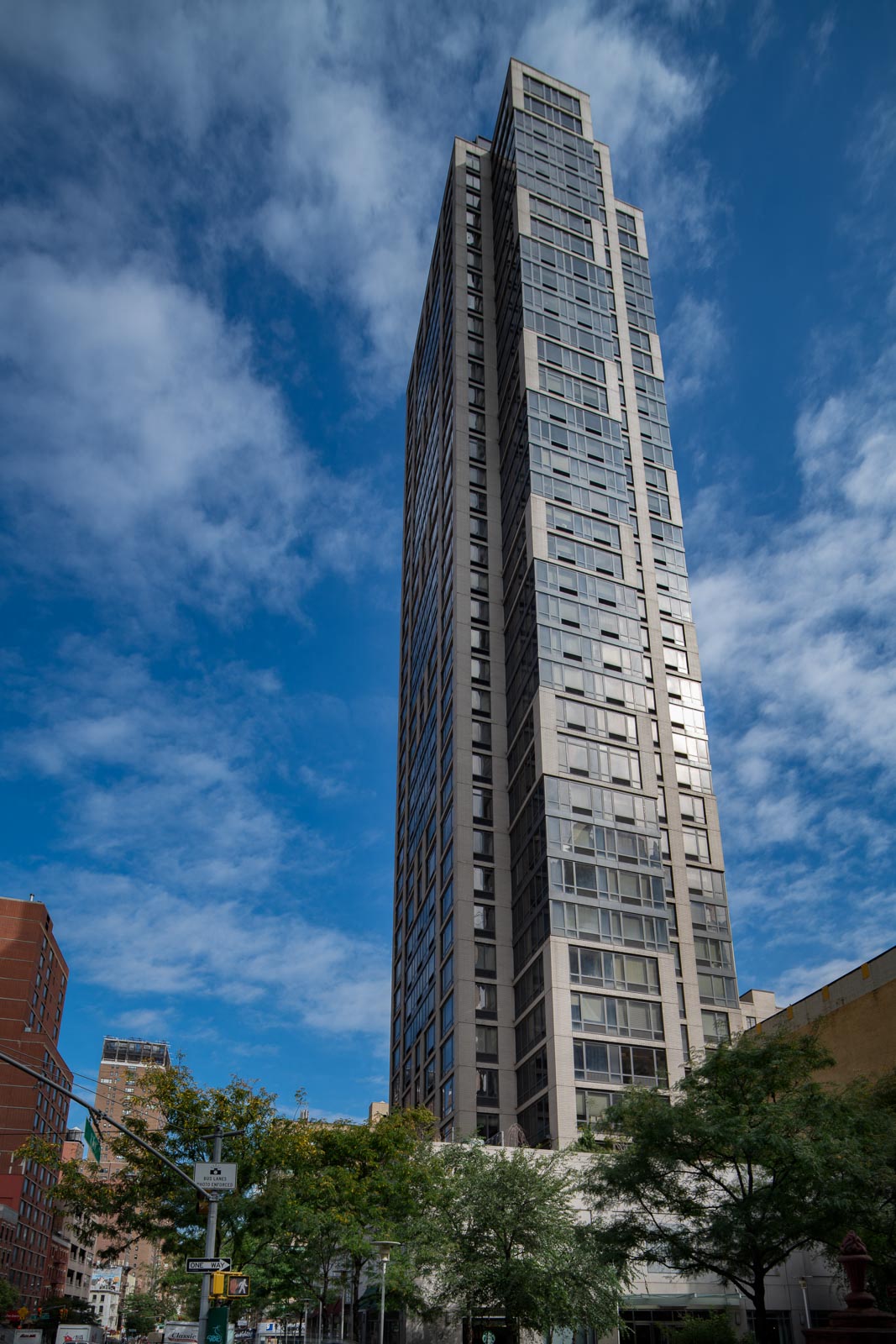 a tall skyscraper in a city against a blue sky