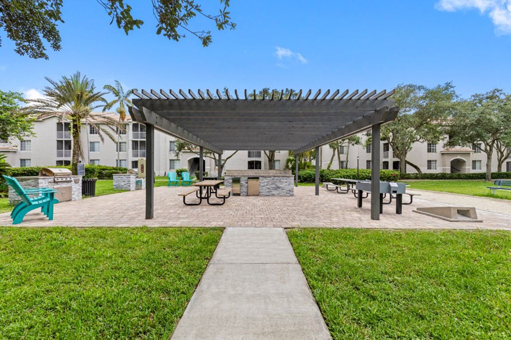 a picnic area with benches and a canopy
