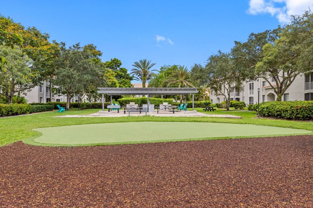 a park with a grassy area and a picnic area