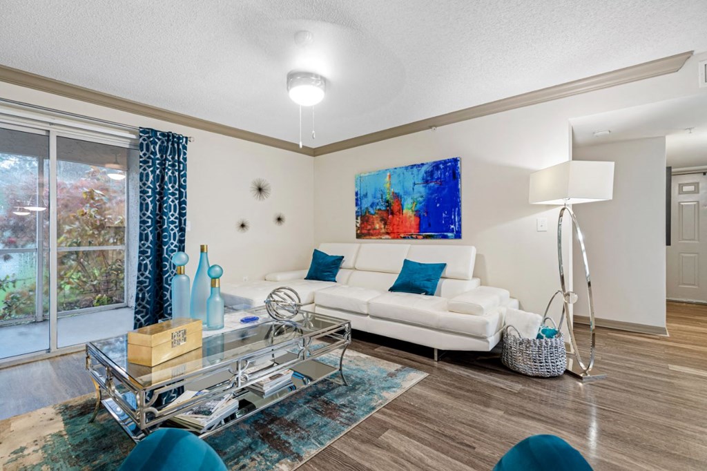 a living room with a white couch and a glass table